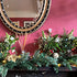 Adding fresh posies to a garland